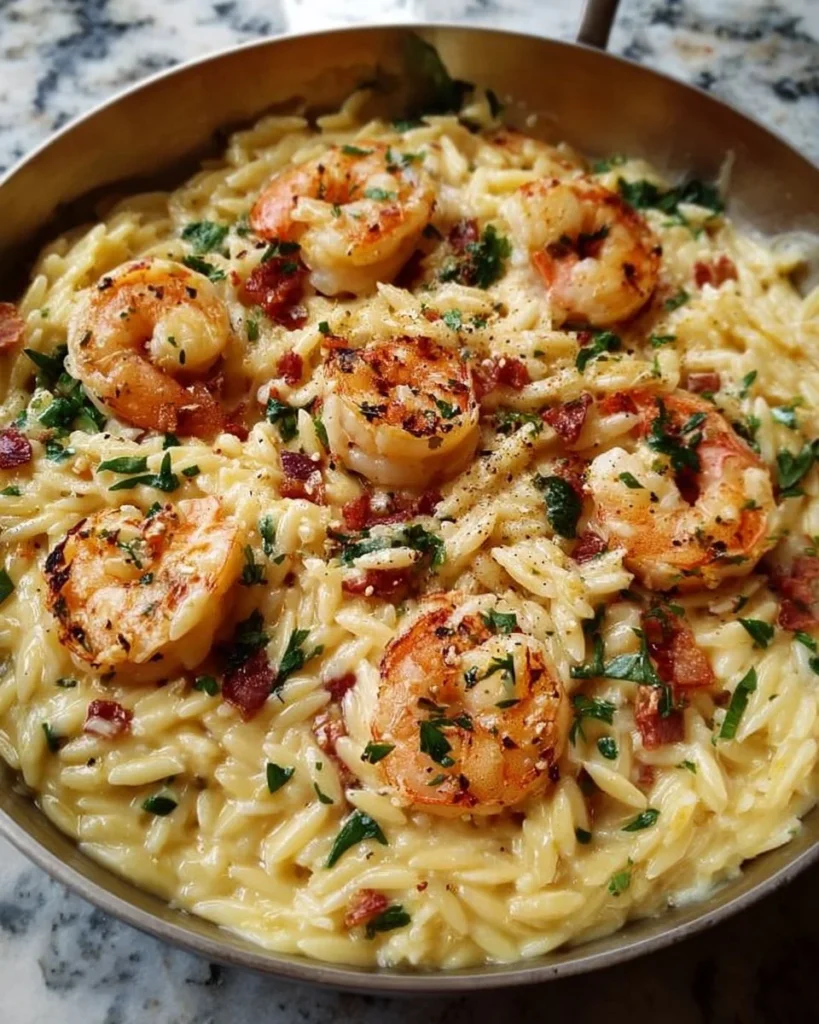 Creamy shrimp orzo served in a bowl with garnishes